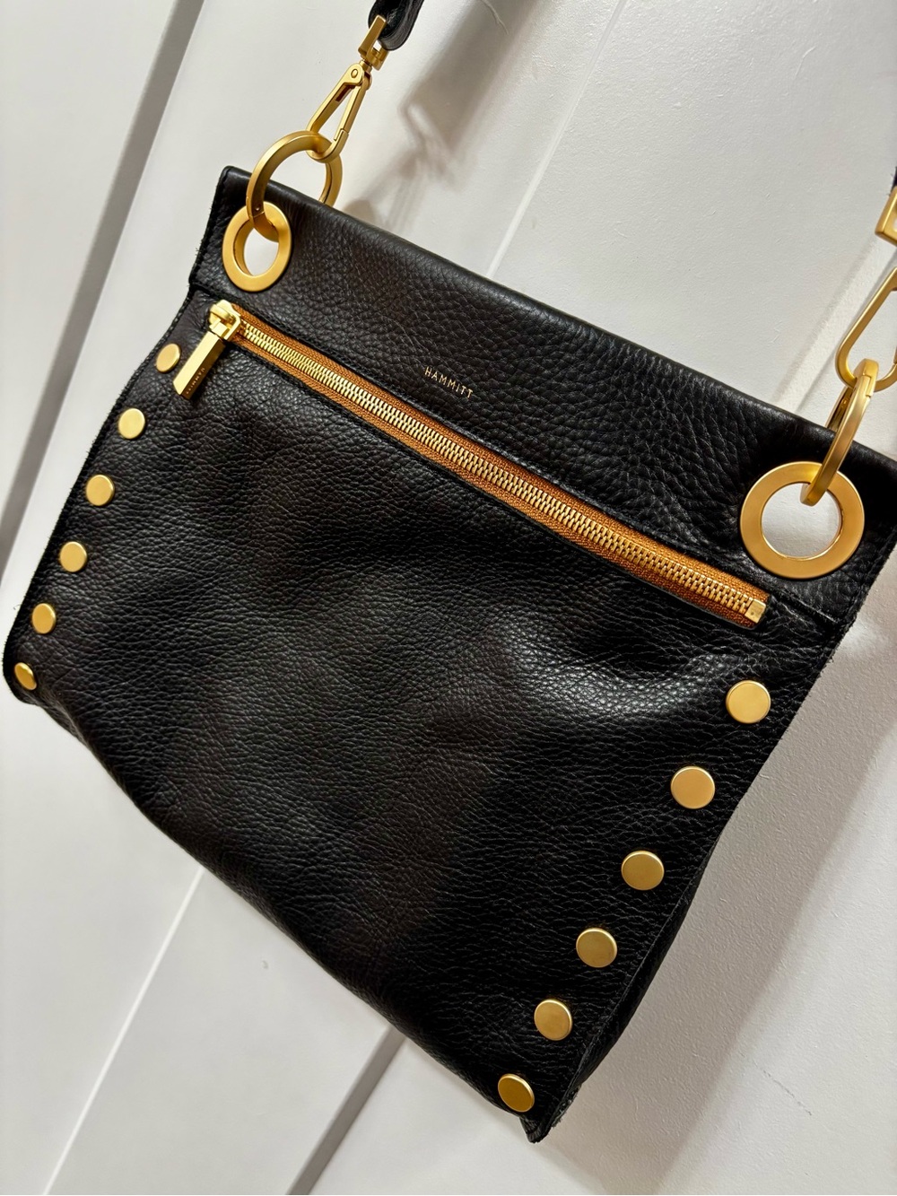 HAMMITT “Tony” Crossbody black leather with brushed gold trim and red zipper